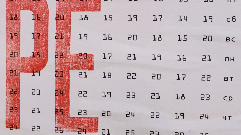 Weekdays in Russian language and dates shown on page of calendar with two drawn big red letters