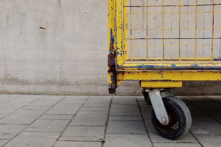 Yellow And Black Metal Cart On Gray Concrete Floor