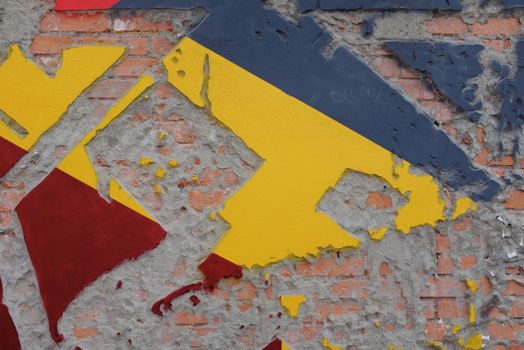Vibrant abstract mural reveals an exposed brick wall background, blending artistic textures.