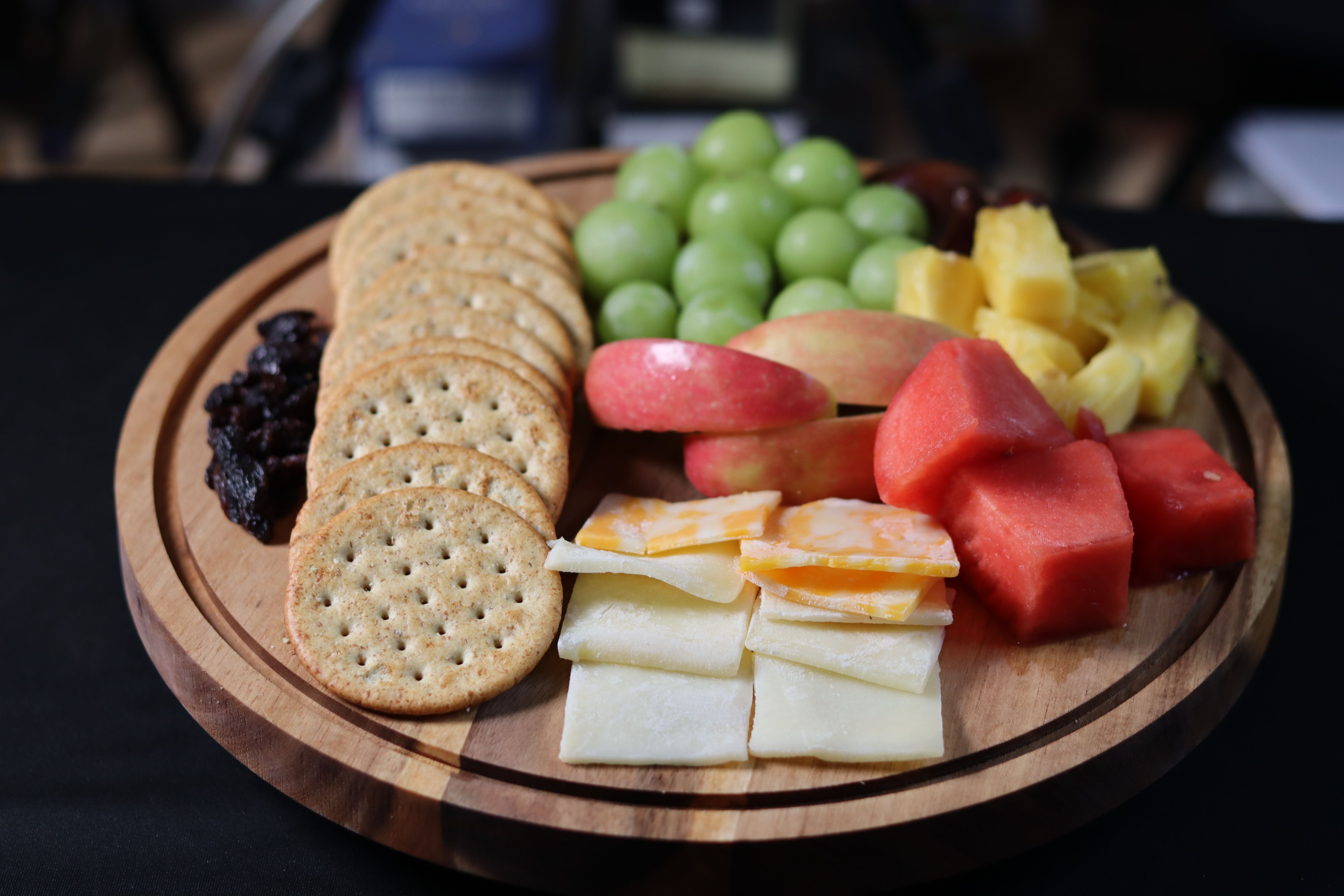 Artisan vegan cheese board with crackers, fruit, and preserves at You Came Again