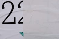 Half of poster on wall in city