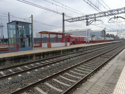 Free View of La Rinconada railway station showing tracks and overhead wires on a clear day. Stock Photo