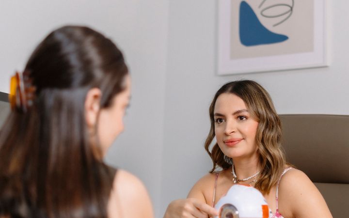 Professional eye health consultation featuring a female doctor discussing optical care with a patient.