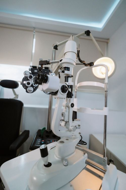 Free A high-tech slit lamp and ophthalmology equipment in a well-lit examination room. Stock Photo