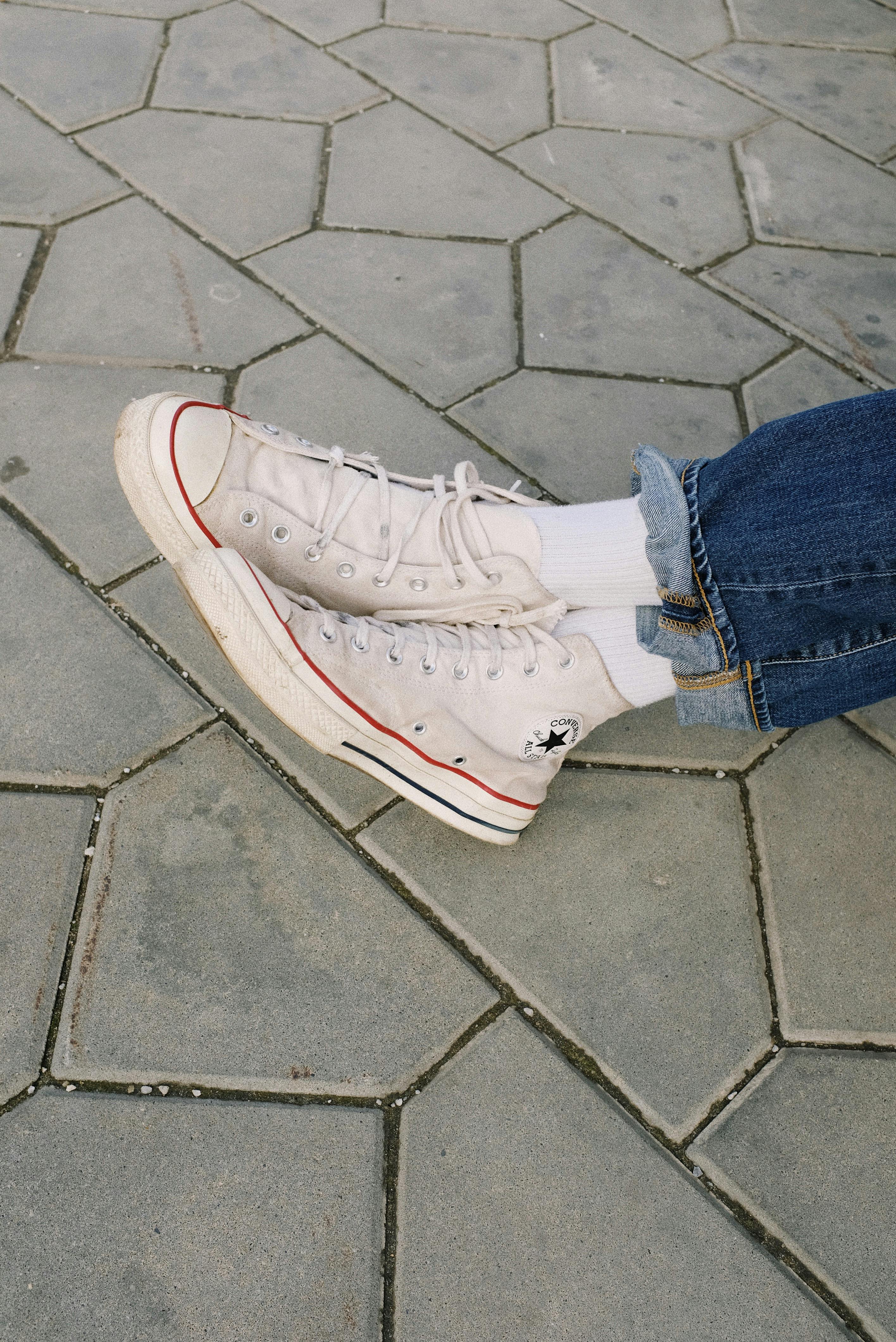 Person Wearing Denim Jeans and White Converse Sneakers · Free Stock Photo