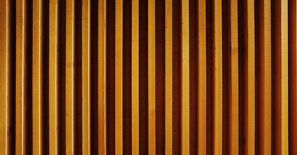 Striped wall constructing from wooden planks · Free Stock Photo