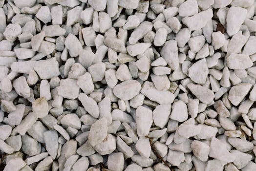 A detailed close-up of white gravel stones showcasing a rough, textured surface.
