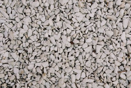 Free Detailed close-up of rough white gravel surface, ideal for texture backgrounds and design projects. Stock Photo