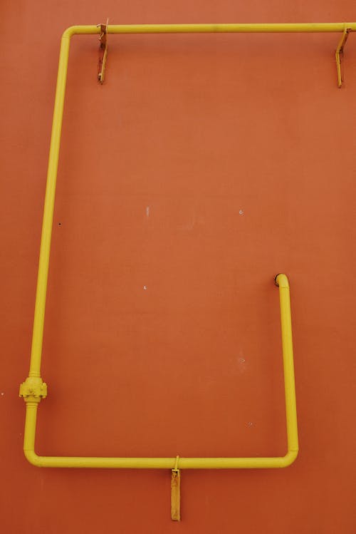 Yellow Pipes on Orange Wall