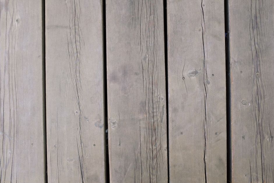 Detailed view of weathered wooden planks, showcasing texture and grain, ideal for backgrounds and design use.