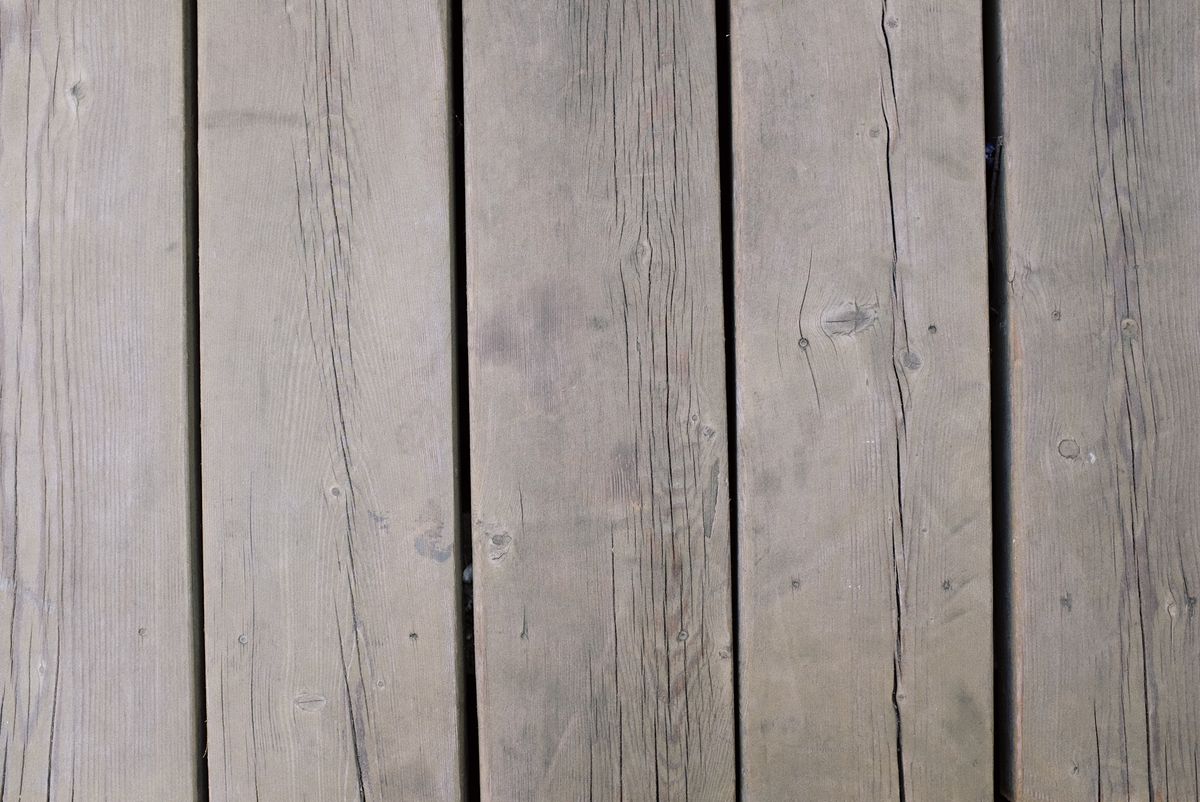 Close-up of weathered wooden deck planks ready for sanding and repair