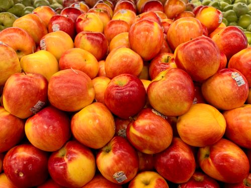Free Vibrant display of fresh red and yellow apples at a market. Perfect for healthy lifestyle concepts. Stock Photo