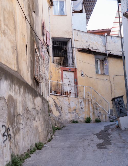 Free Charming rustic buildings line a narrow alleyway in İzmir, Türkiye. Stock Photo