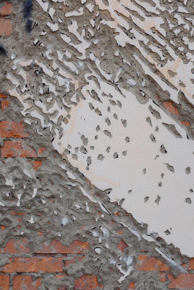 Broken concrete wall with aged and deteriorating surface