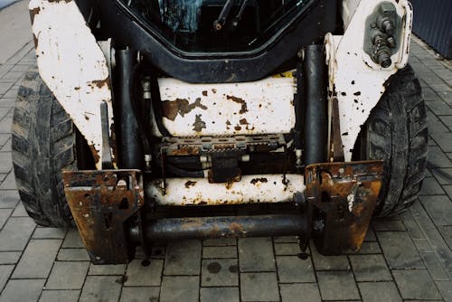 From above place of arm installation on shabby heavy duty mini loader with white frame