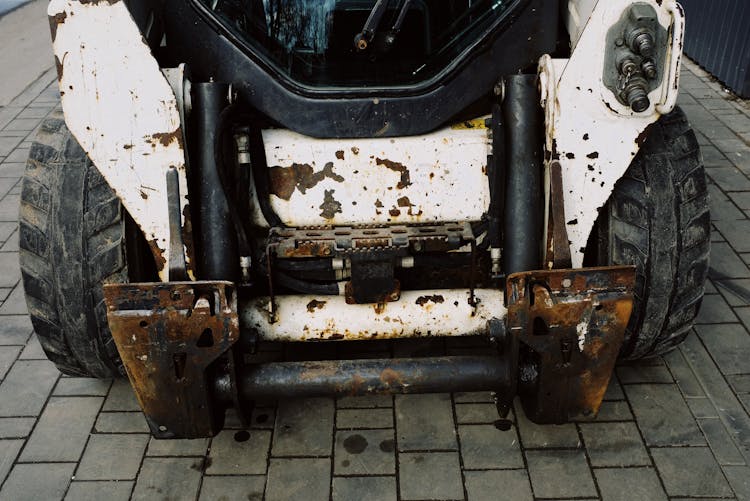 Mini Loader With Removed Arm Waiting To Be Repaired