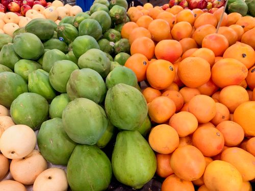 Free Vibrant display of fresh fruits including papayas, oranges, and melons at a market in Tarneit, Australia. Stock Photo