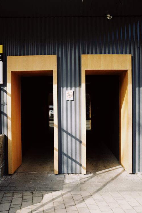 Free Two modern wooden doorways with natural light casting shadows. Stock Photo