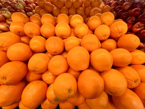 Free Vibrant display of ripe oranges and apples at a market. Ideal stock photo for food and health themes. Stock Photo