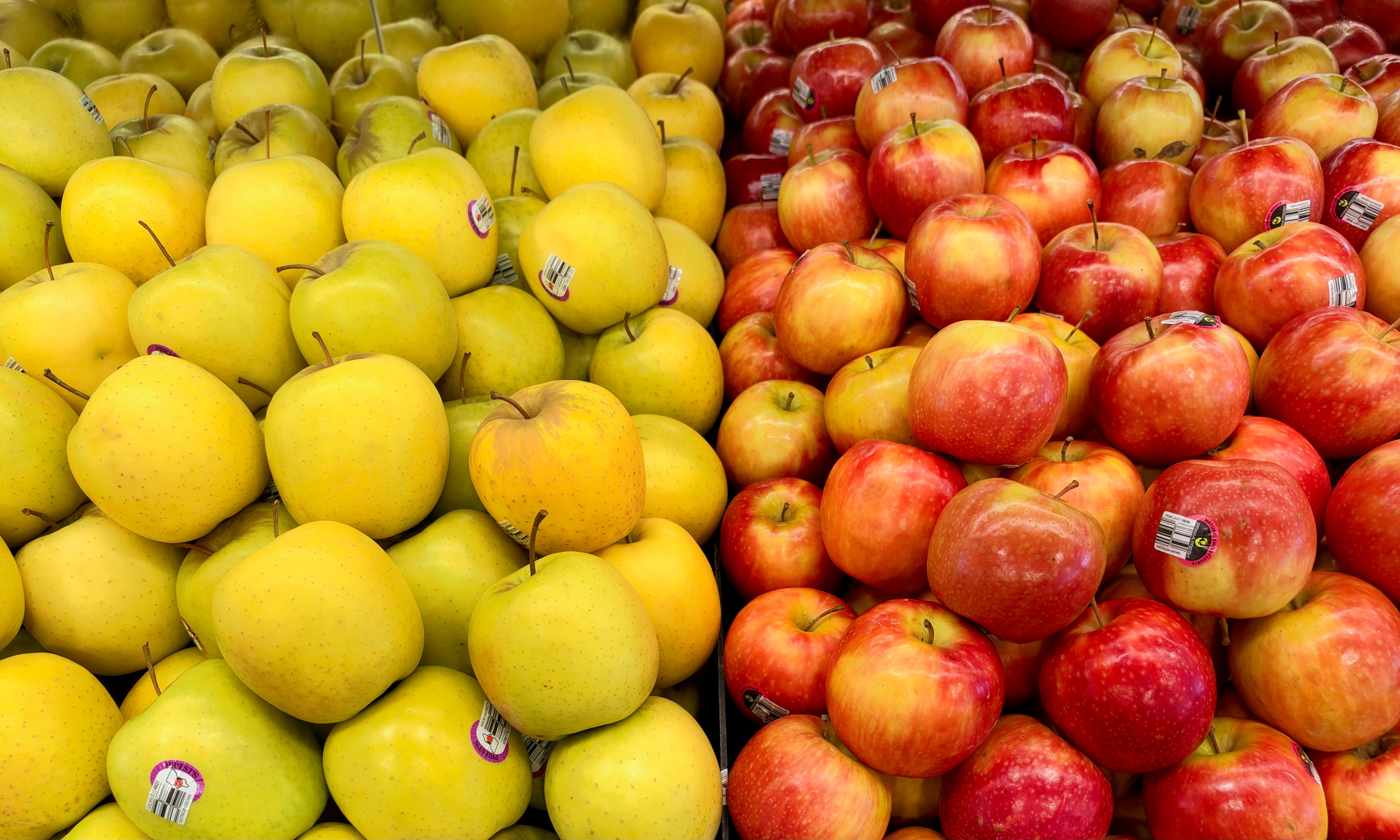 Vibrant display of yellow and red apples at a market in Tarneit, Victoria, Australia.