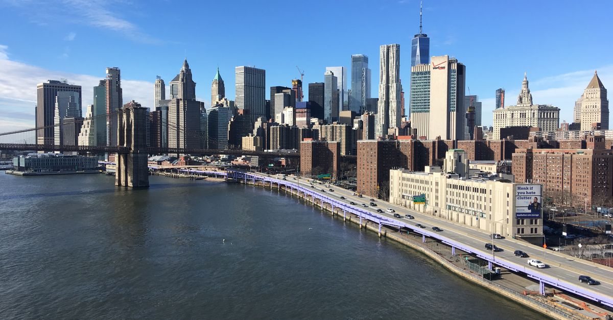 A stunning view of the New York City skyline featuring the Brooklyn Bridge from daytime.
