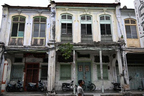 Free Historic colonial buildings with weathered facade in urban setting, featuring parked motorcycles. Stock Photo