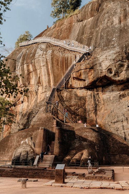 Free Sigiriya Rock Fortress in Sri Lanka with its iconic staircase ascending the rock face. Stock Photo