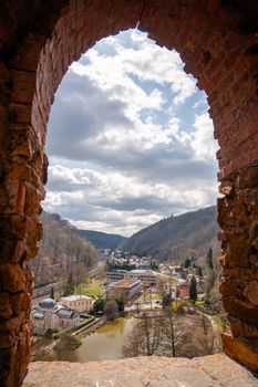 Captivating view of Tharandt, Germany through a rustic brick archway on a clear day.