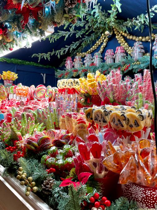 Free Brightly colored lollipops and sweets on display at a festive Christmas market stall. Stock Photo