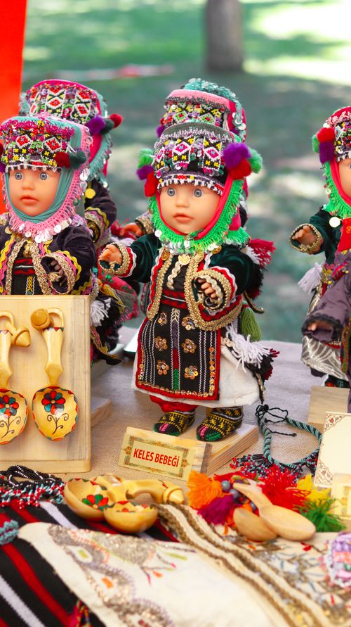 Free Vibrant traditional dolls in intricate costumes at a market stall. Stock Photo