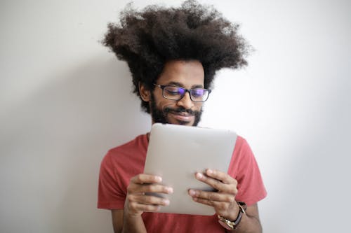 Free Man in Red Shirt Holding an Ipad Stock Photo