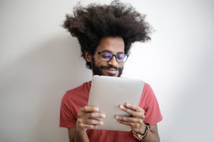 Man In Red Shirt Holding An Ipad