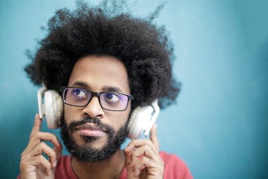 Portrait of a man with afro hairstyle enjoying music with headphones. Vibrant and stylish.