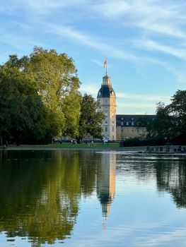 Scenic view of Karlsruhe Palace reflecting in the lake at sunset.