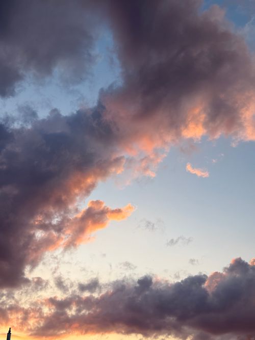 Free Stunning view of vibrant pink and purple clouds at sunset in a clear sky. Stock Photo