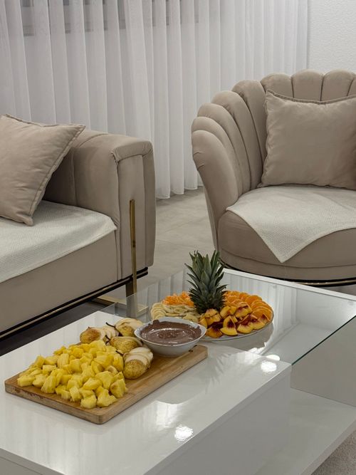 Free Luxurious indoor scene of a modern living room with tropical fruit platter on a glass table. Stock Photo