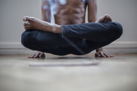 Man in lotus pose levitating indoors, focusing on yoga and meditation.