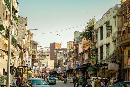 Free Vibrant street life in Lahore with people, vehicles, and classic architecture under a clear sky. Stock Photo