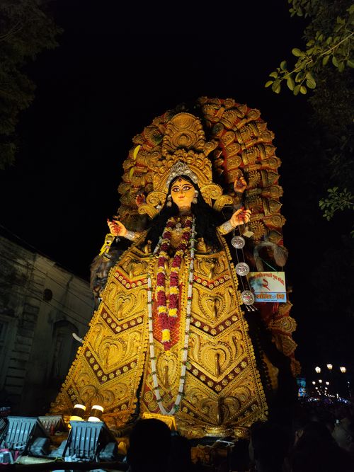 Free Stunning nighttime view of a grand Durga idol adorned with intricate decorations during a festival. Stock Photo