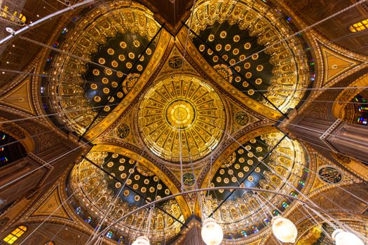 Intricate details of a golden mosque dome featuring elaborate patterns.