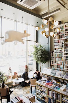 A warm, inviting coffee shop filled with books and a comfortable reading area.