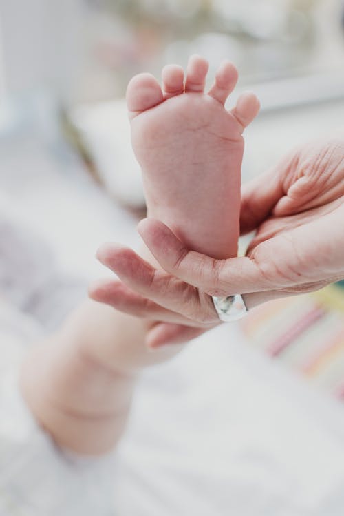 Free Person Holding Baby's Foot Stock Photo