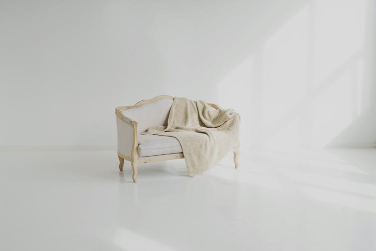 White Towel On White Wooden Sofa