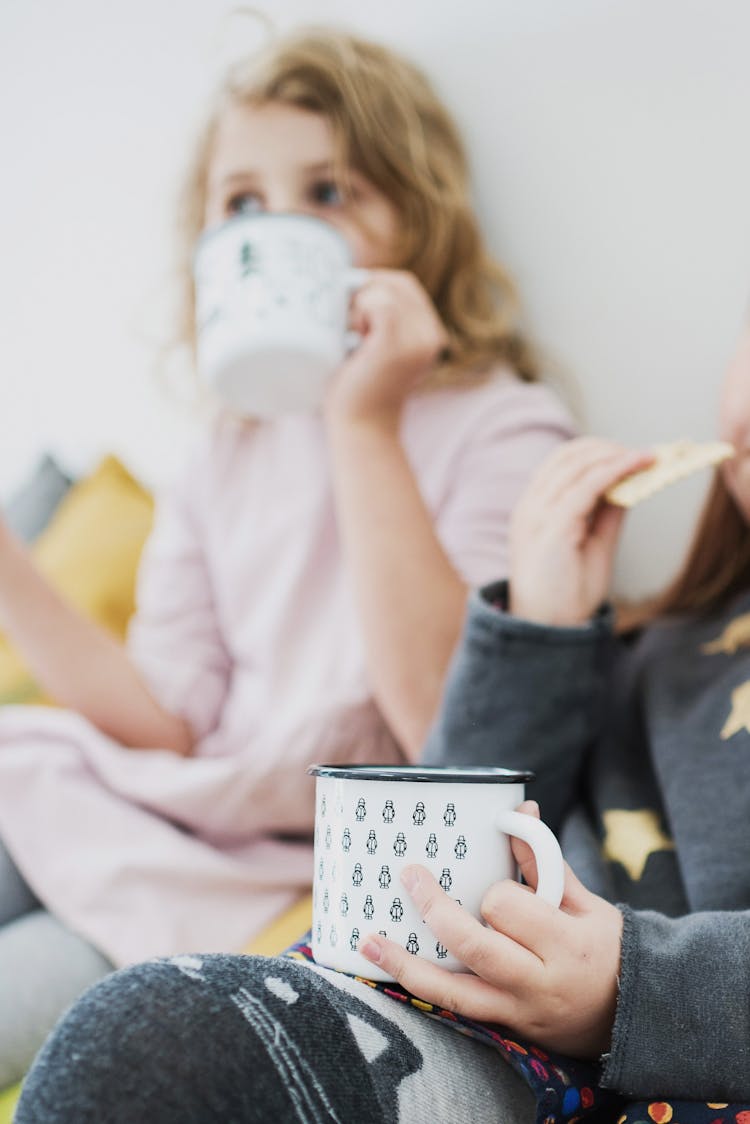 Girls Drinking Milk And Eating Biscuits