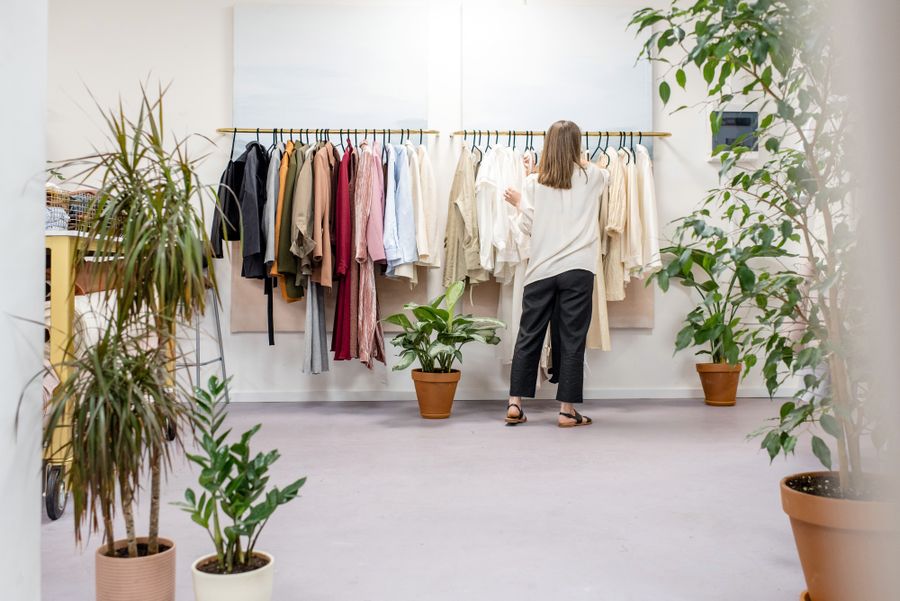 Woman browsing an elegant boutique with curated racks