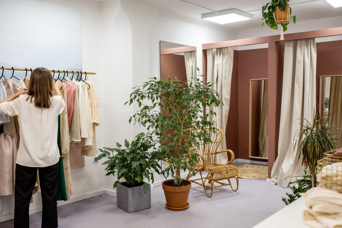 Tailor taking measurements for custom garment