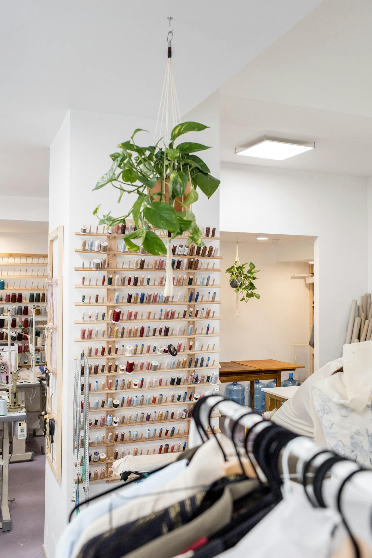 Cozy bedroom with clothes rack and natural light creating a calm minimalist space
