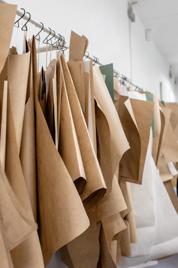 Set Of Sewing Patterns On Hangers Inside Tailor Atelier Or Studio