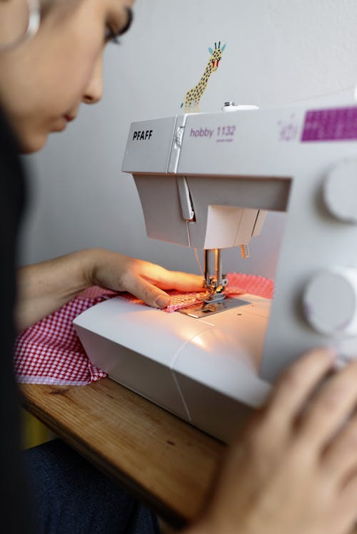 Woman  Using White Sewing Machine