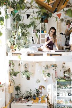 Young woman inside modern stylish room with two tier layout and floral design